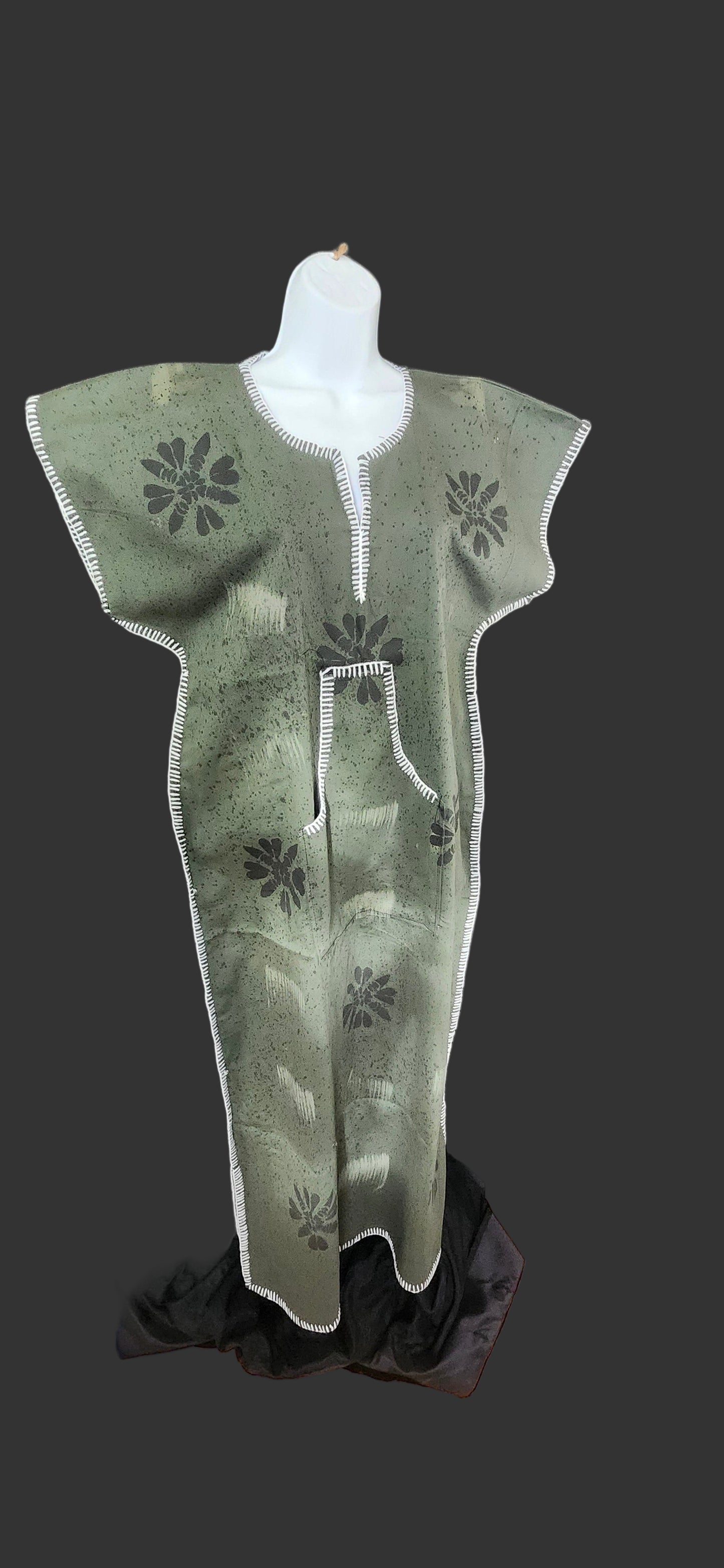 Green and white patterned dress on a black surface