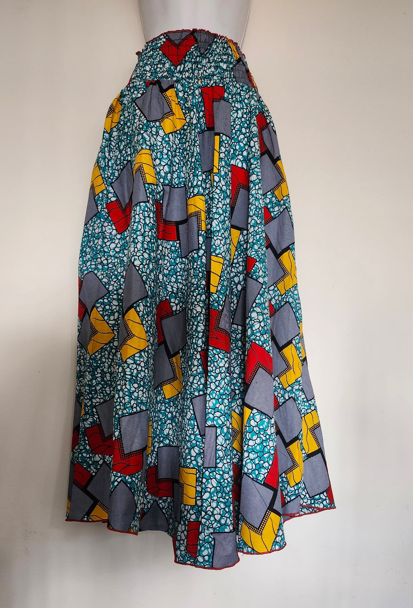 Colorful patterned fabric on a mannequin with a white background