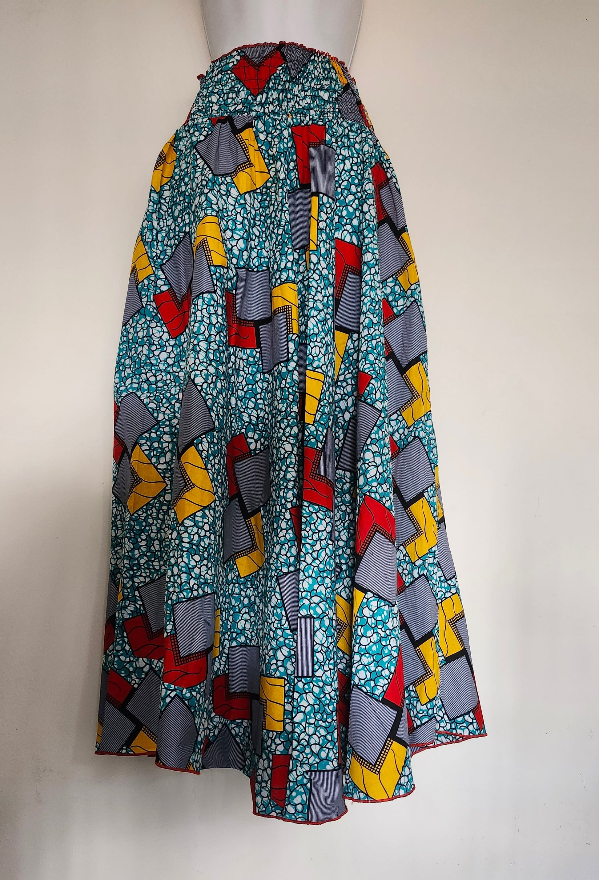 Colorful patterned fabric on a mannequin with a white background