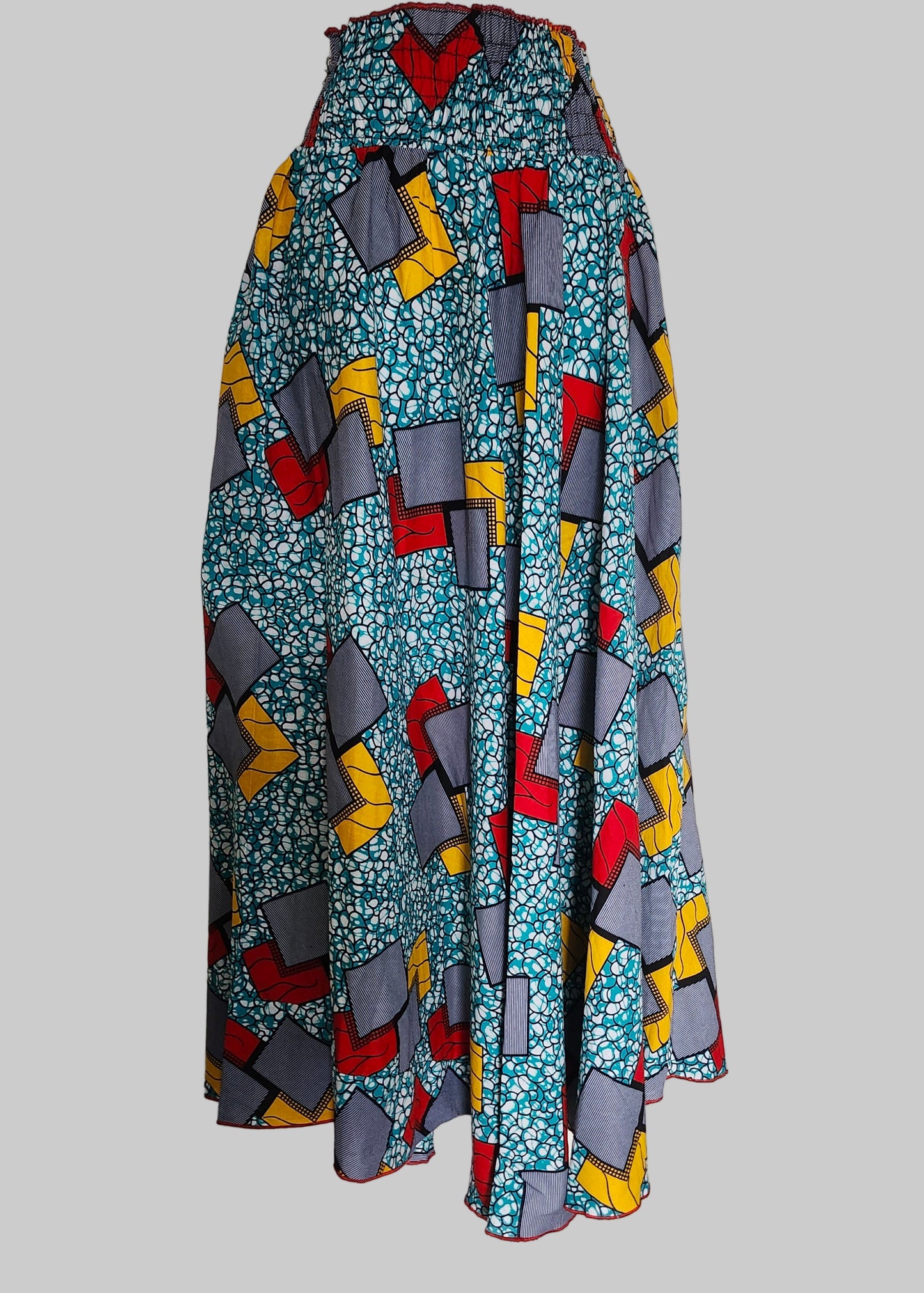 Colorful geometric-patterned skirt on a mannequin against a plain background