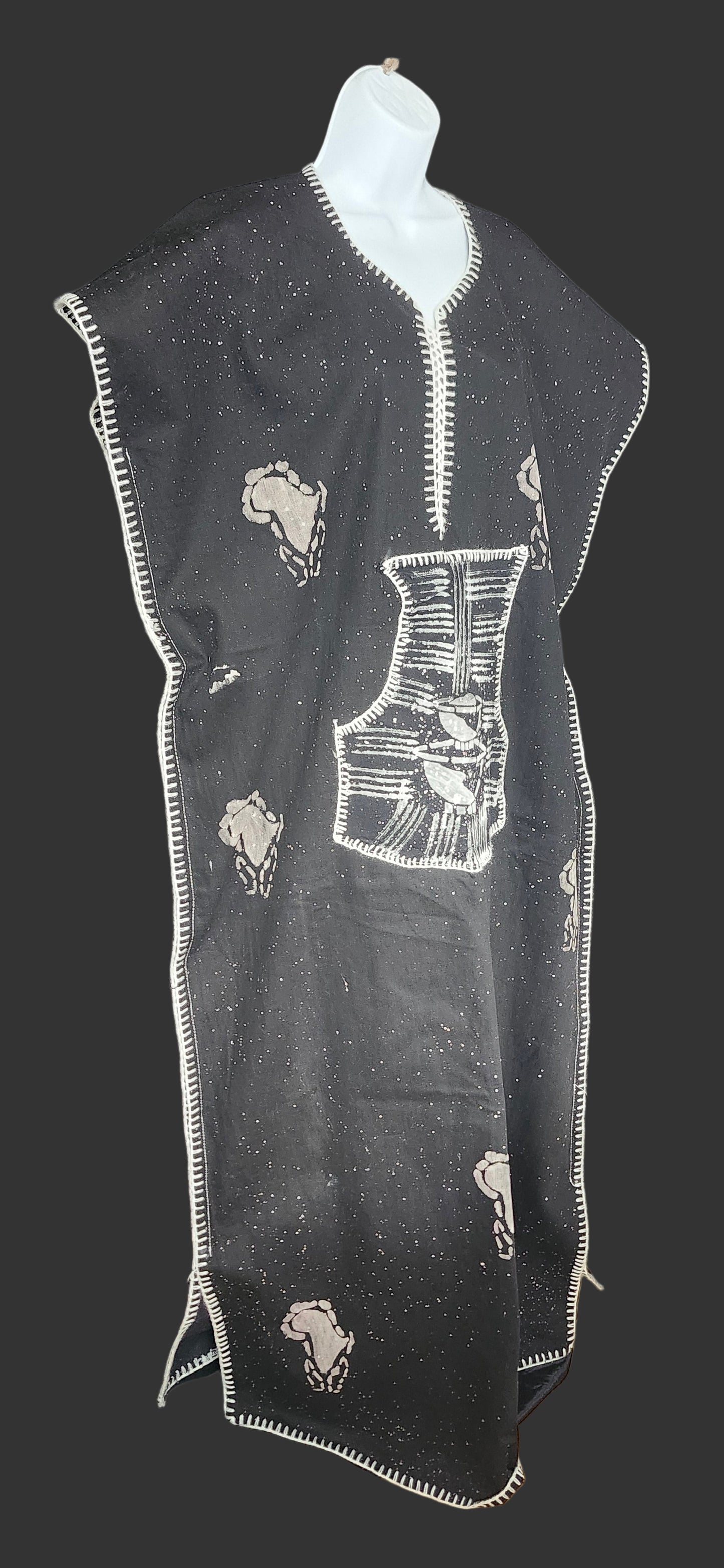 Black fabric with white embroidery on a dark surface