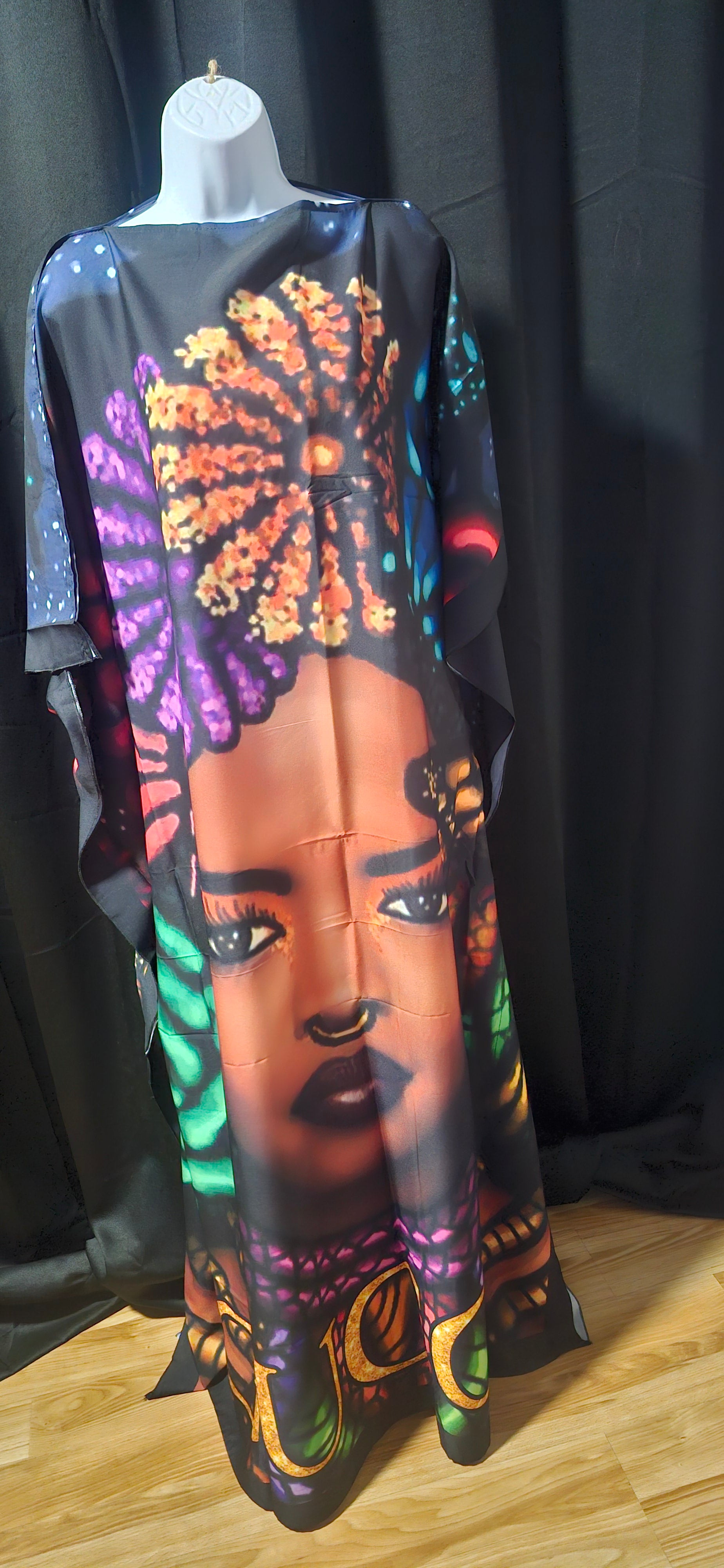 Colorful art piece with a stylized face and abstract design on a black background