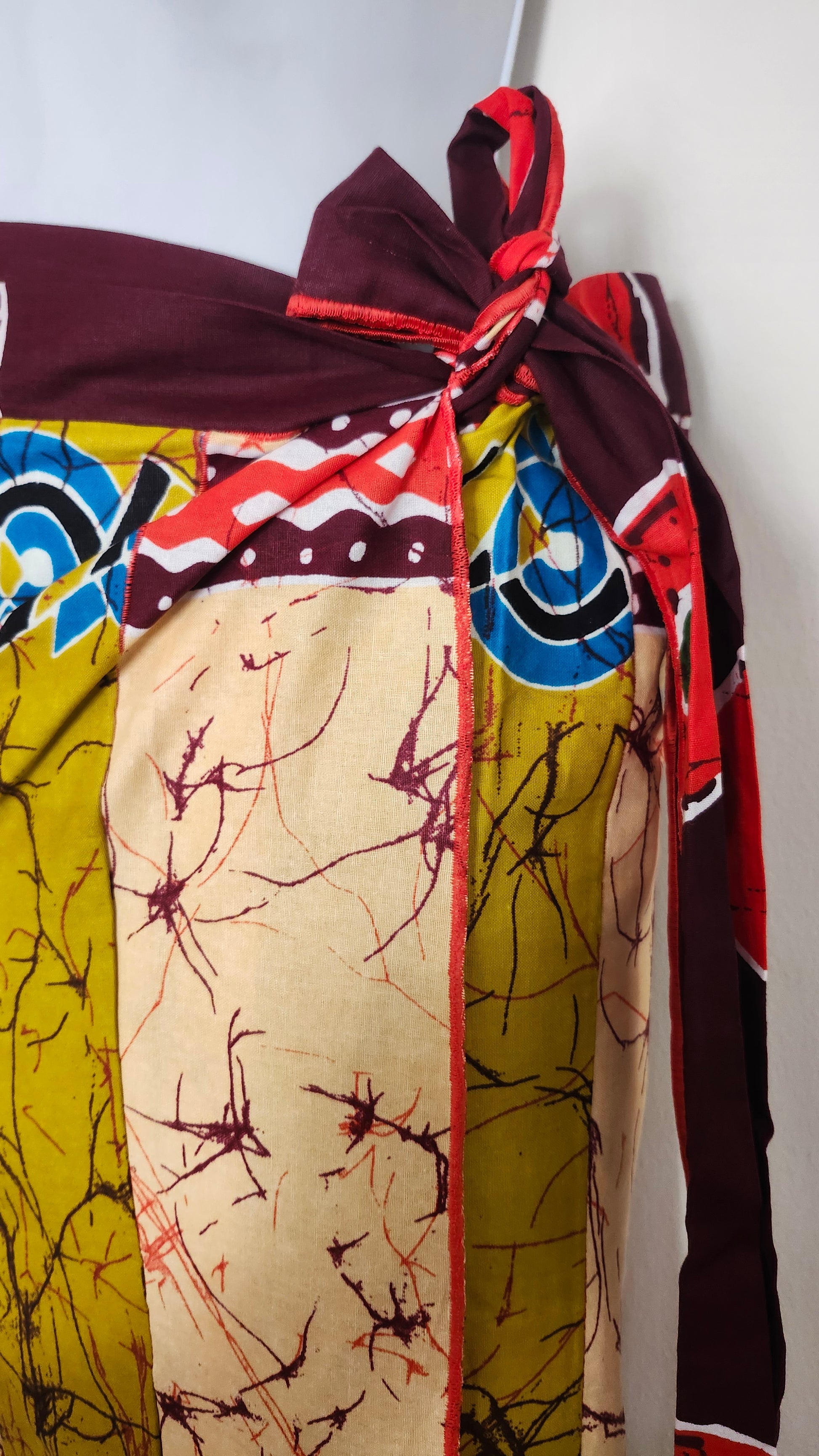 Colorful fabric with patterns and a tied bow on a white background