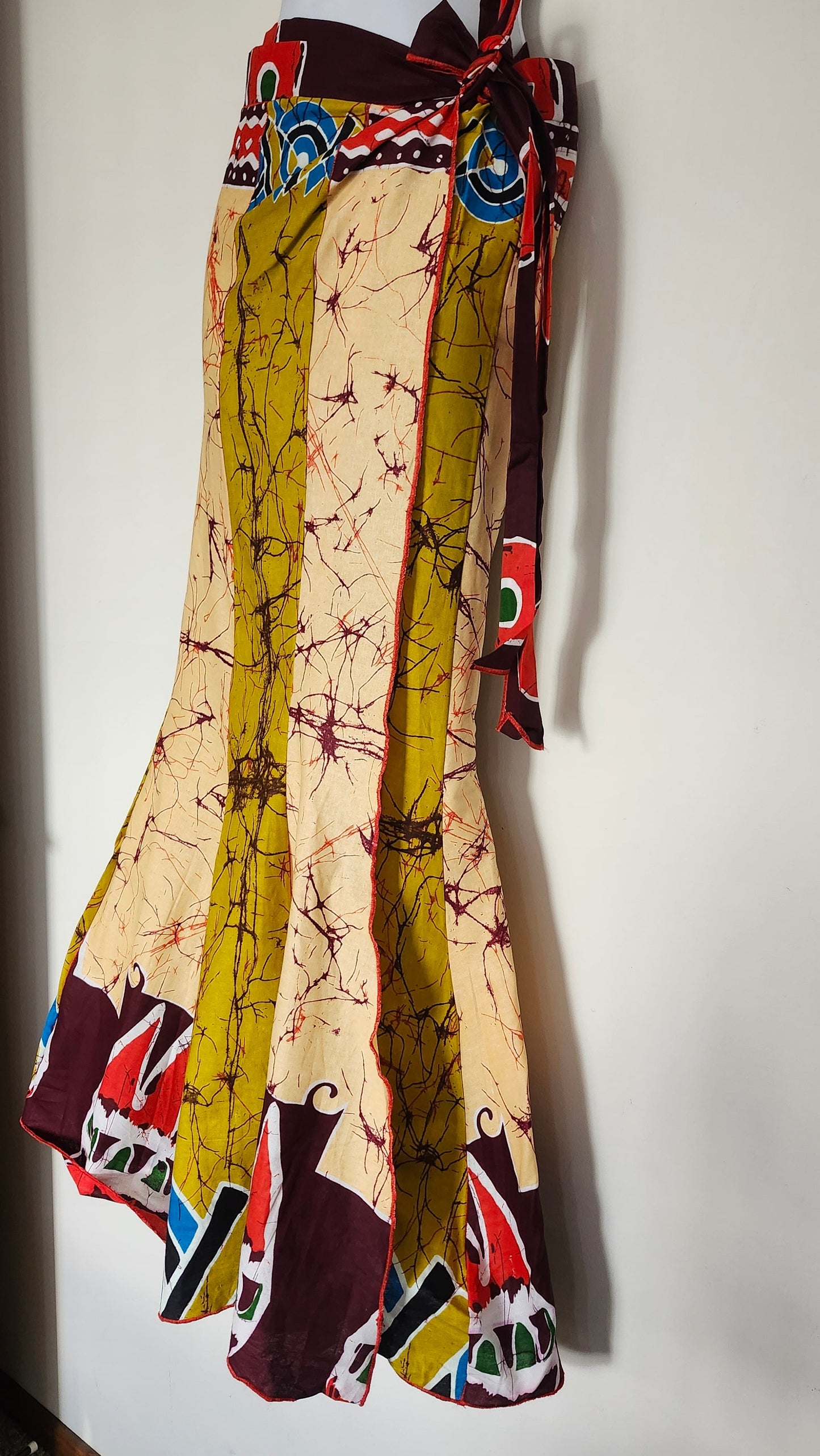 Colorful patterned skirt on a mannequin against a white background