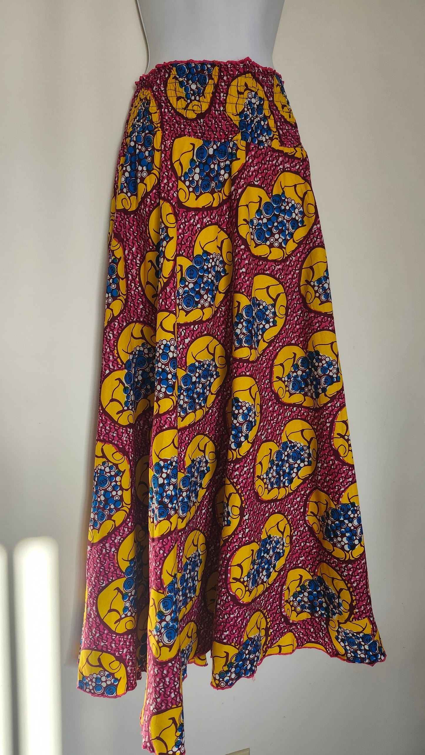 Dark Red, yellow and blue fabric with a colorful pattern on a white surface