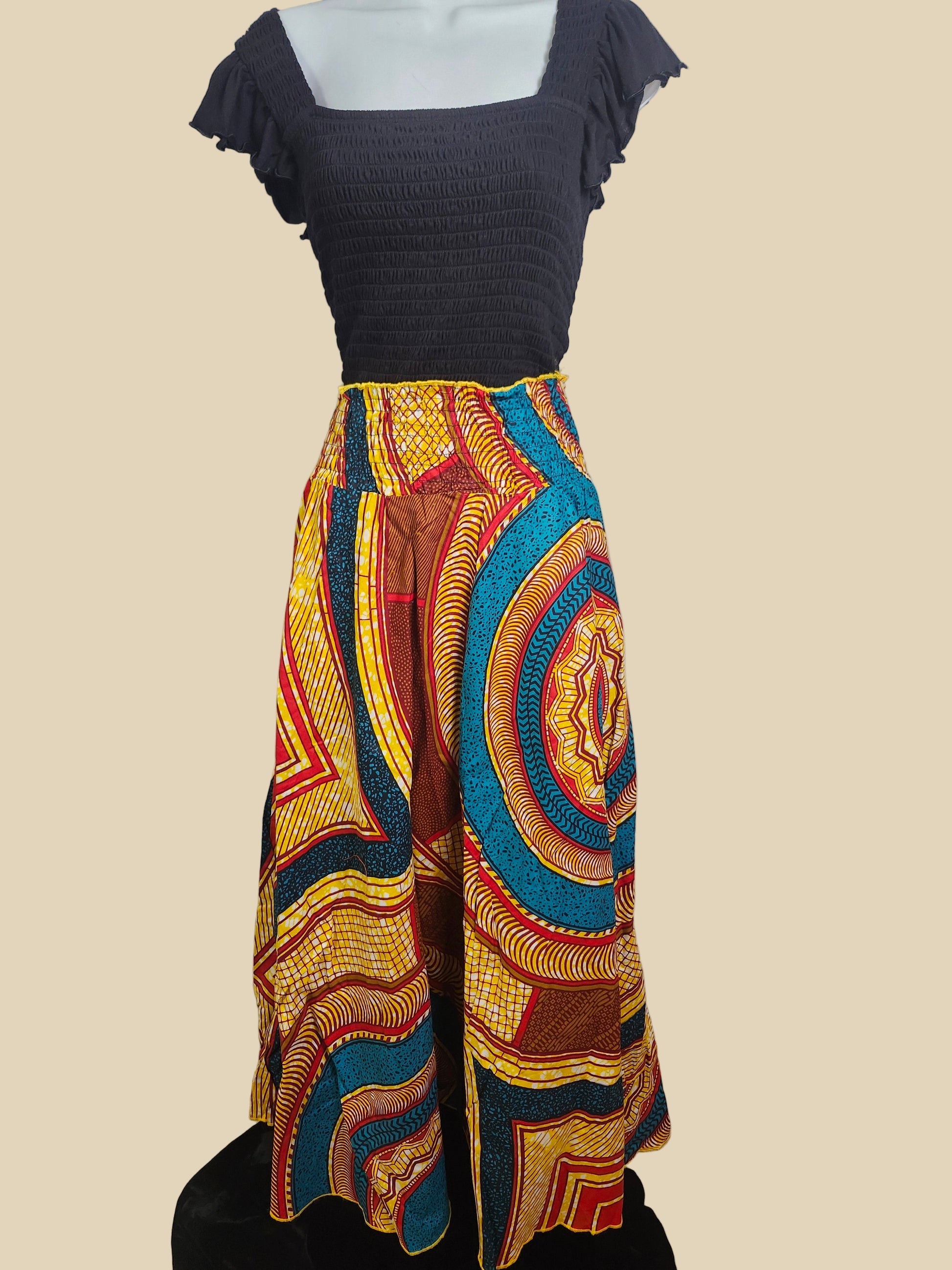 Colorful patterned fabric draped over a chair against a plain wall.