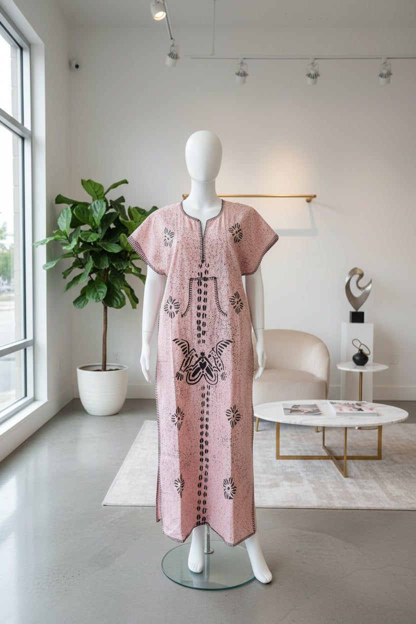 Decorative pink garment with floral patterns on a black surface