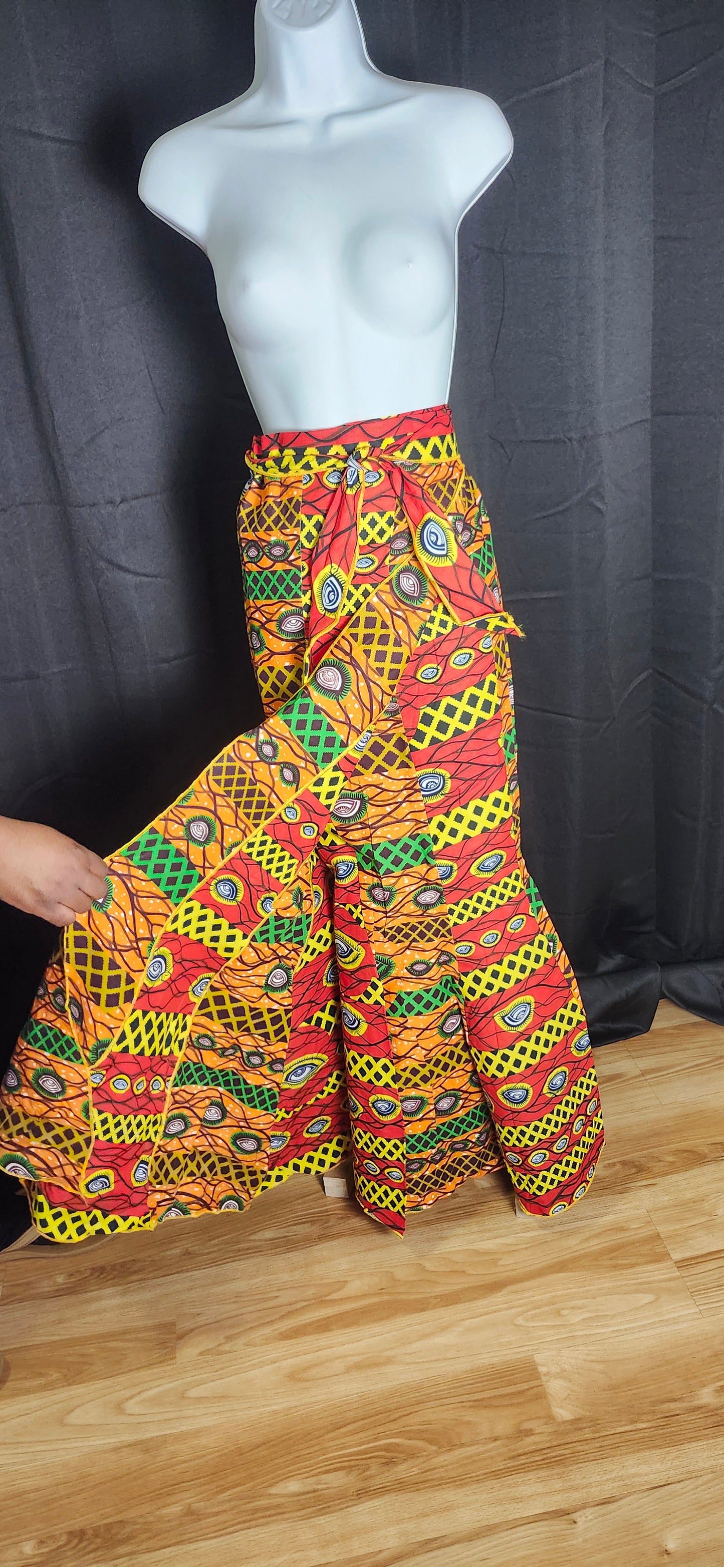 Colorful red, green, orange and yellow patterned dress tied with belt
