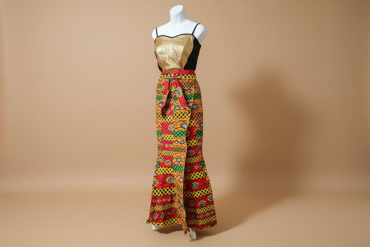 Colorful patterned fabric draped over a mannequin on a black surface.