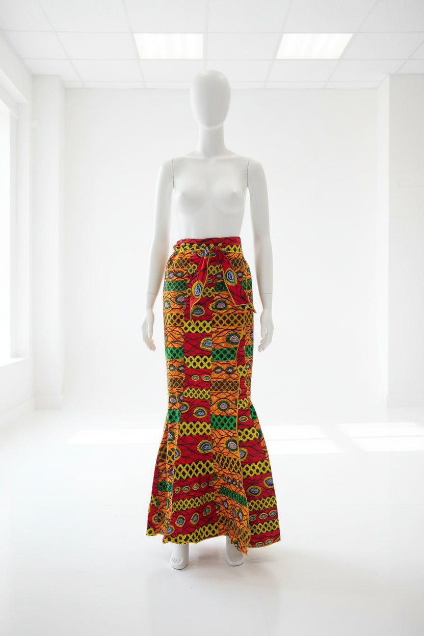 Colorful patterned fabric on a mannequin arm against a black background