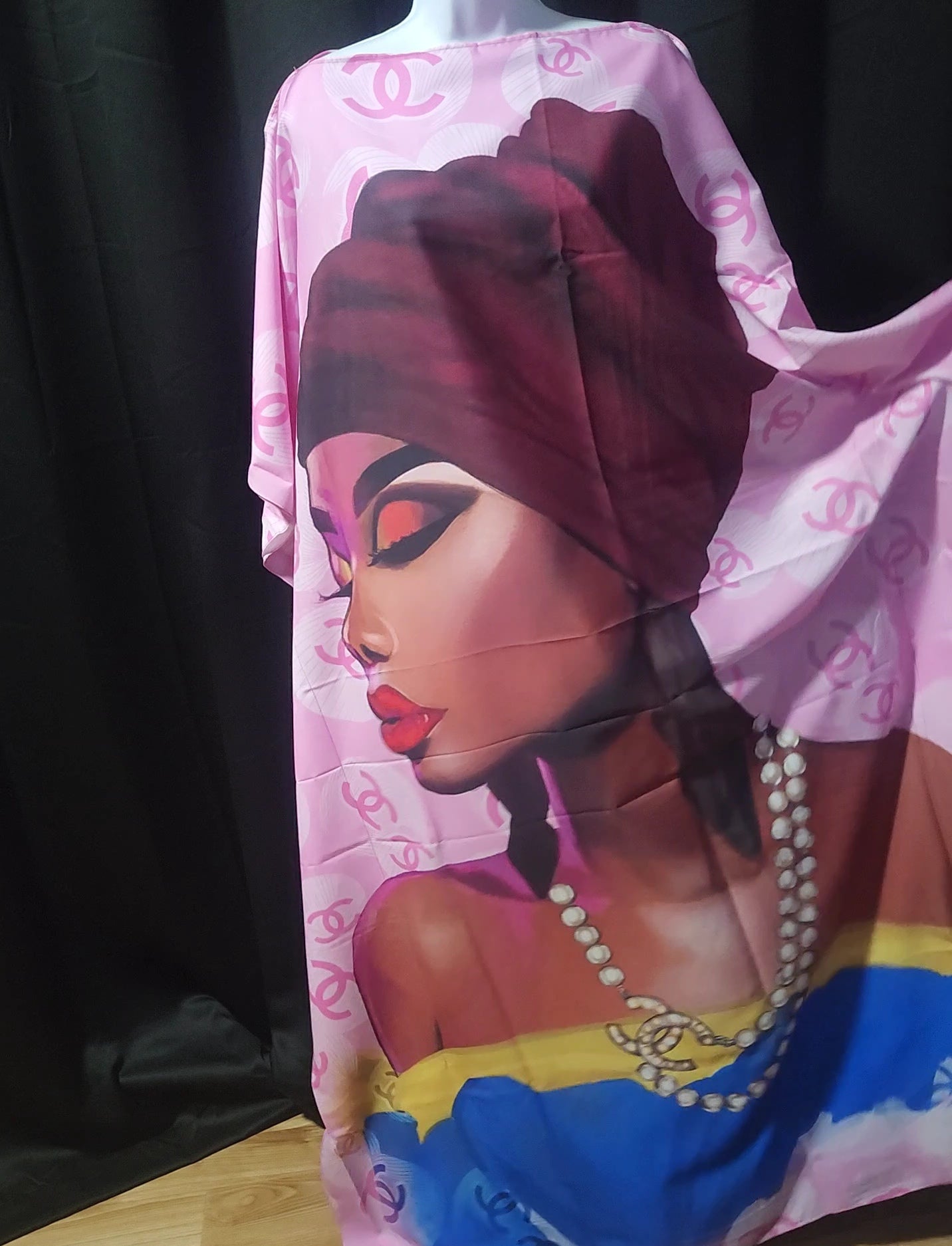 Pink dress with a colorful design of a woman's face